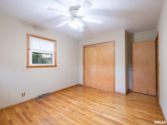 204 Ivanhoe Way, Bloomington, IL 61701 - unfurnished bedroom featuring light wood finished floors, a closet, and ceiling fan
