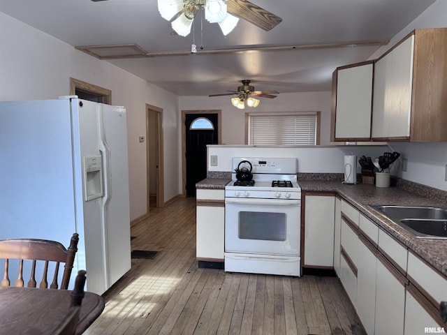 1807 N 5th St, Chillicothe, IL 61523 - kitchen featuring white appliances, ceiling fan, light wood finished floors, white cabinets, and dark countertops