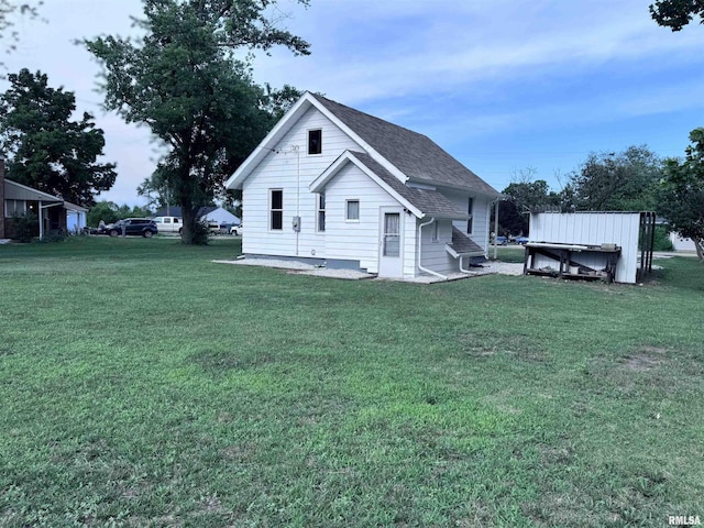 1807 N 5th St, Chillicothe, IL 61523 - rear view of property with a yard and a shingled roof
