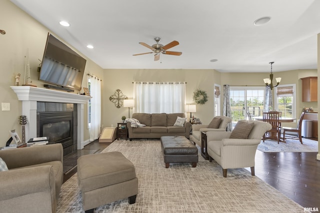 10615 N Collett Rd, Peoria, IL 61615 - living area with hardwood / wood-style floors, recessed lighting, a fireplace, ceiling fan, and a chandelier