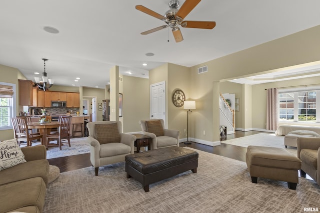 10615 N Collett Rd, Peoria, IL 61615 - living area featuring wood finished floors, a chandelier, stairs, a ceiling fan, and recessed lighting
