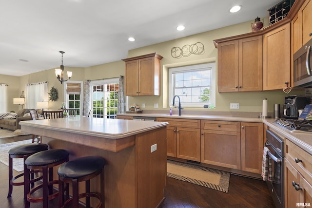 10615 N Collett Rd, Peoria, IL 61615 - kitchen with stainless steel appliances, dark wood finished floors, healthy amount of natural light, a breakfast bar area, and recessed lighting