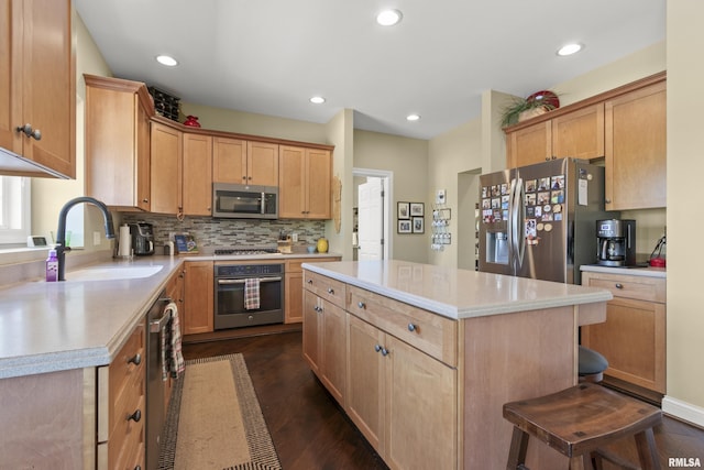 10615 N Collett Rd, Peoria, IL 61615 - kitchen featuring appliances with stainless steel finishes, light countertops, a kitchen island, dark wood-type flooring, and recessed lighting