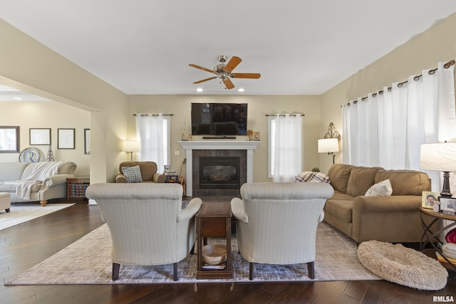 10615 N Collett Rd, Peoria, IL 61615 - living room with plenty of natural light, a tiled fireplace, dark wood finished floors, a ceiling fan, and recessed lighting