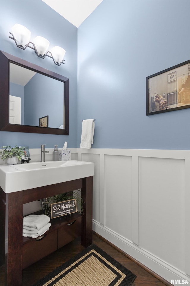 10615 N Collett Rd, Peoria, IL 61615 - bathroom with wood finished floors, wainscoting, a decorative wall, and vanity