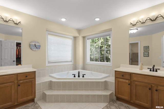 10615 N Collett Rd, Peoria, IL 61615 - bathroom featuring two vanities, a bath, and tile patterned floors