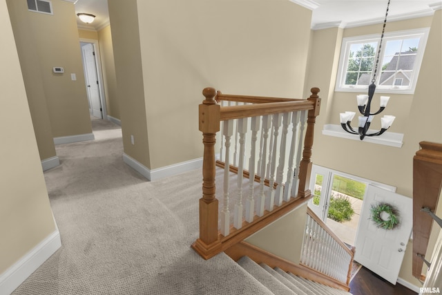 10615 N Collett Rd, Peoria, IL 61615 - staircase featuring a chandelier, ornamental molding, and carpet