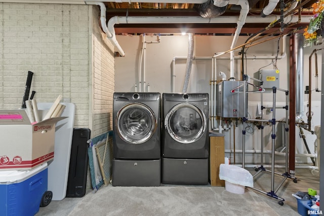10615 N Collett Rd, Peoria, IL 61615 - laundry area featuring washer and clothes dryer, tankless water heater, and brick wall