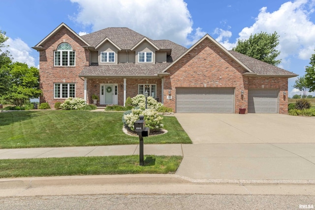 10615 N Collett Rd, Peoria, IL 61615 - traditional-style house featuring driveway, a garage, a front yard, brick siding, and a shingled roof
