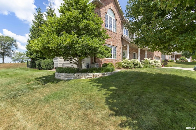 10615 N Collett Rd, Peoria, IL 61615 - view of front of property with brick siding, a front yard, and a garage