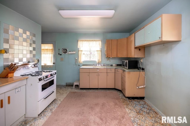1425 Arthur St, Pekin, IL 61554 - kitchen featuring white gas stove, stainless steel microwave, and light countertops