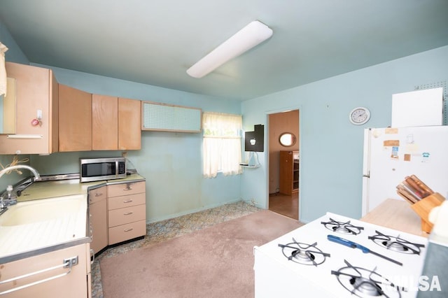 1425 Arthur St, Pekin, IL 61554 - kitchen with stainless steel microwave, freestanding refrigerator, light brown cabinets, and light countertops