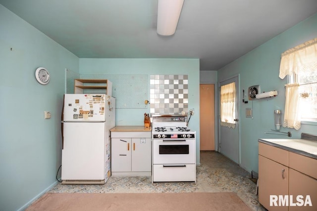 1425 Arthur St, Pekin, IL 61554 - kitchen with white appliances, plenty of natural light, and light countertops