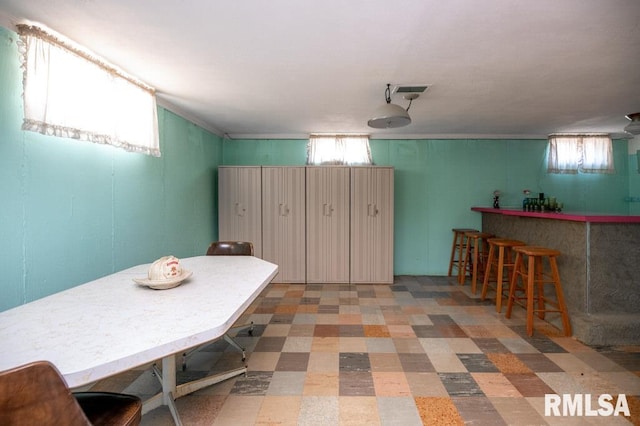 1425 Arthur St, Pekin, IL 61554 - dining room with healthy amount of natural light, tile patterned floors, and bar area