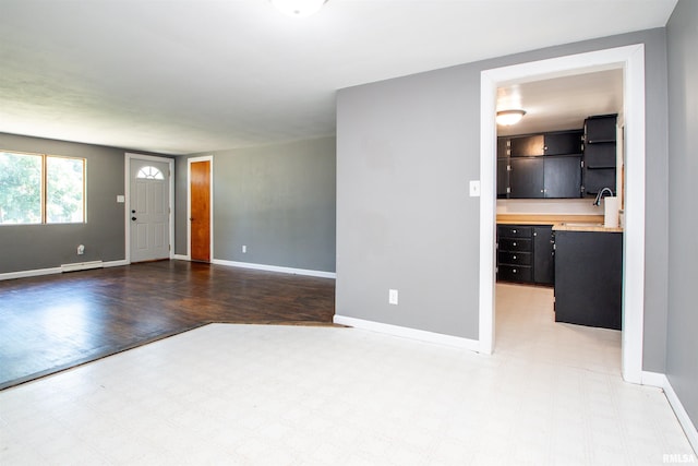 416 W Maple St, Chillicothe, IL 61523 - unfurnished living room with a baseboard radiator and baseboards