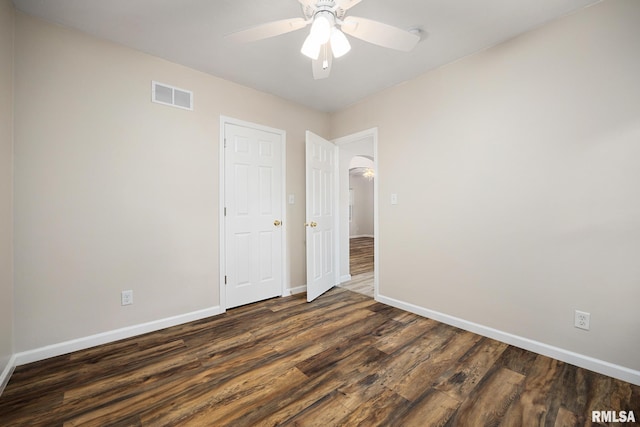 117 Hazel Ct, Creve Coeur, IL 61610 - unfurnished bedroom featuring wood finished floors, arched walkways, and ceiling fan