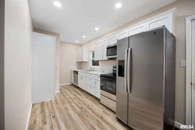 117 Hazel Ct, Creve Coeur, IL 61610 - kitchen featuring appliances with stainless steel finishes, white cabinets, light countertops, light wood-style flooring, and recessed lighting