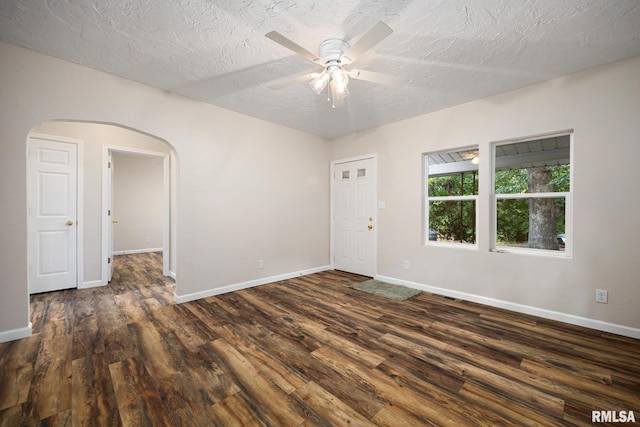 117 Hazel Ct, Creve Coeur, IL 61610 - spare room with arched walkways, dark wood finished floors, a ceiling fan, and a textured ceiling