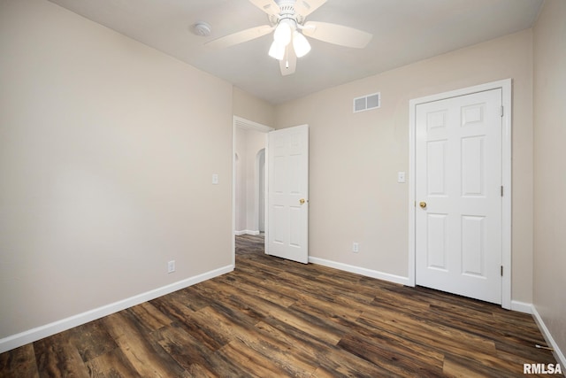 117 Hazel Ct, Creve Coeur, IL 61610 - unfurnished bedroom with dark wood finished floors, a ceiling fan, and arched walkways