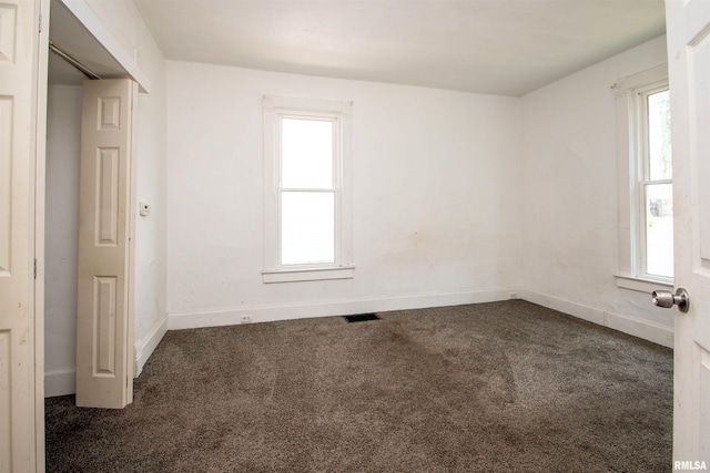 2211 N Bigelow St, Peoria, IL 61604 - unfurnished bedroom with dark colored carpet and multiple windows