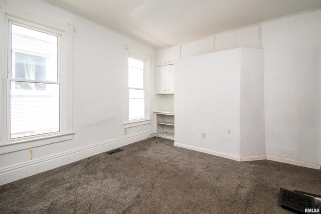 2211 N Bigelow St, Peoria, IL 61604 - spare room with dark carpet and baseboards