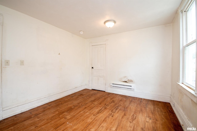 2211 N Bigelow St, Peoria, IL 61604 - unfurnished room with light wood-style floors, a baseboard radiator, and a smoke detector
