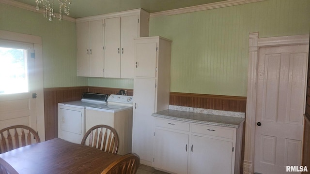 658 E Maple St, Canton, IL 61520 - laundry room with washer and clothes dryer, wainscoting, cabinet space, and wood walls