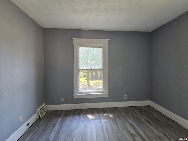 1310 N Sheridan Rd, Peoria, IL 61606 - spare room featuring dark wood-style floors and a textured ceiling
