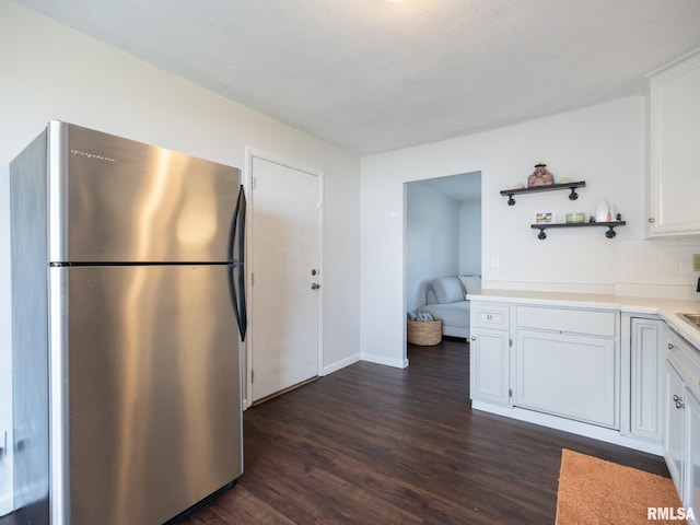 6110 N Idlewhile Dr, Peoria, IL 61614 - kitchen with freestanding refrigerator, dark wood-style flooring, white cabinets, light countertops, and open shelves