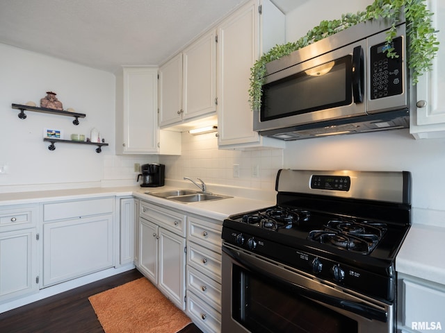 6110 N Idlewhile Dr, Peoria, IL 61614 - kitchen with appliances with stainless steel finishes, light countertops, open shelves, white cabinets, and backsplash