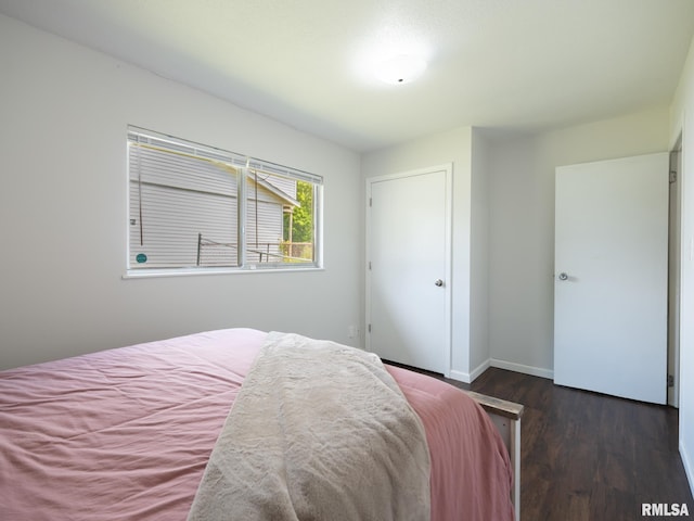 6110 N Idlewhile Dr, Peoria, IL 61614 - bedroom featuring dark wood-style flooring and baseboards