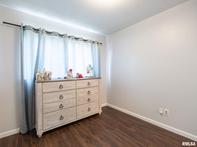 6110 N Idlewhile Dr, Peoria, IL 61614 - bedroom with baseboards and dark wood-type flooring