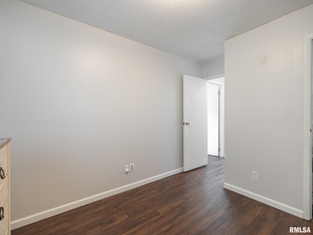 6110 N Idlewhile Dr, Peoria, IL 61614 - spare room with dark wood-type flooring and baseboards