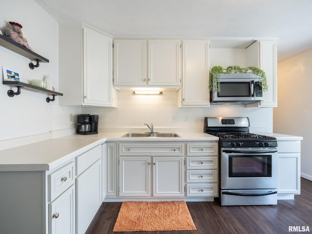 6110 N Idlewhile Dr, Peoria, IL 61614 - kitchen with stainless steel appliances, open shelves, and dark wood-style floors