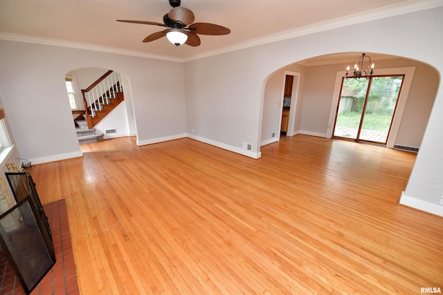 300 E Embert Pl, Peoria, IL 61603 - unfurnished living room featuring crown molding, light wood finished floors, ceiling fan, arched walkways, and a chandelier