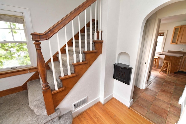 300 E Embert Pl, Peoria, IL 61603 - stairway featuring baseboards and arched walkways