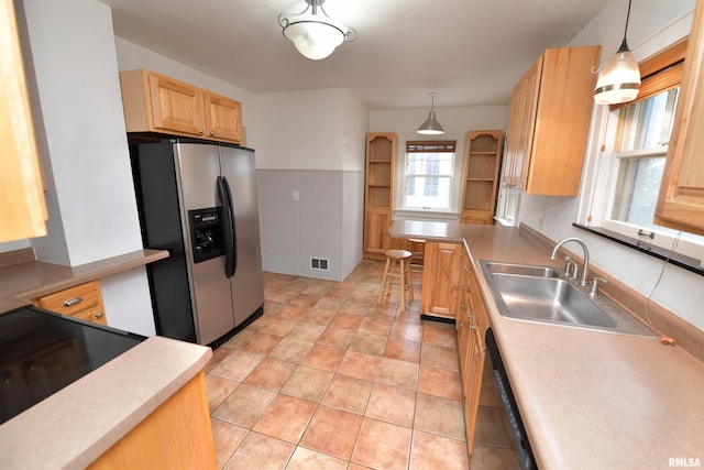 300 E Embert Pl, Peoria, IL 61603 - kitchen with stainless steel refrigerator with ice dispenser, light brown cabinetry, decorative light fixtures, light countertops, and a wainscoted wall