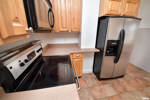 300 E Embert Pl, Peoria, IL 61603 - kitchen with stainless steel appliances, light tile patterned floors, light countertops, and light brown cabinets