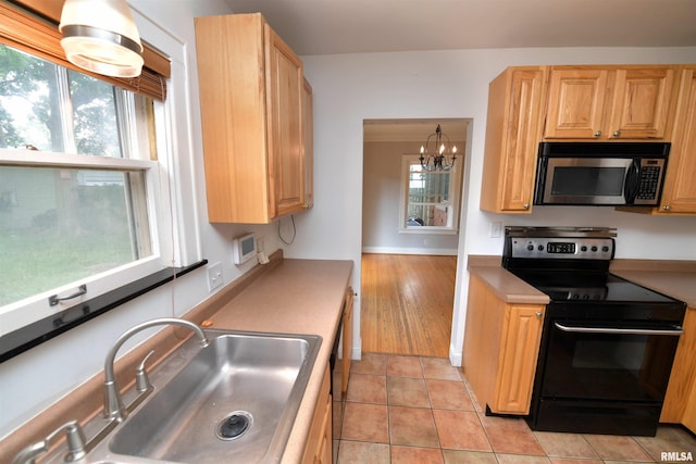 300 E Embert Pl, Peoria, IL 61603 - kitchen featuring stainless steel microwave, electric range, a chandelier, light countertops, and light tile patterned floors