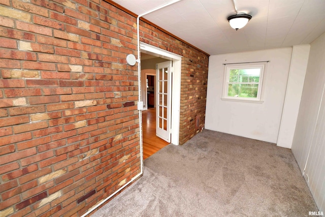 300 E Embert Pl, Peoria, IL 61603 - carpeted spare room featuring brick wall and french doors