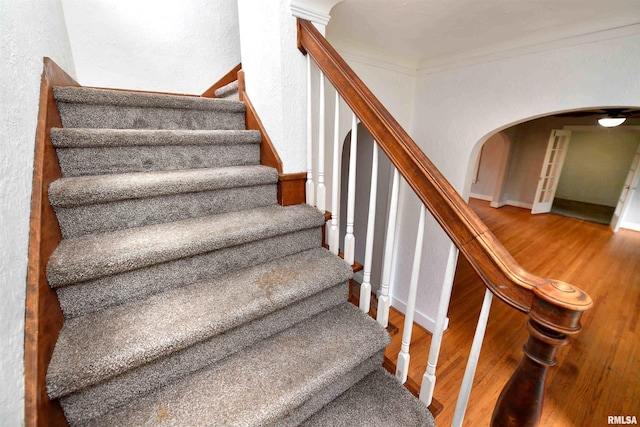 300 E Embert Pl, Peoria, IL 61603 - staircase with wood finished floors, arched walkways, ornamental molding, and a textured wall