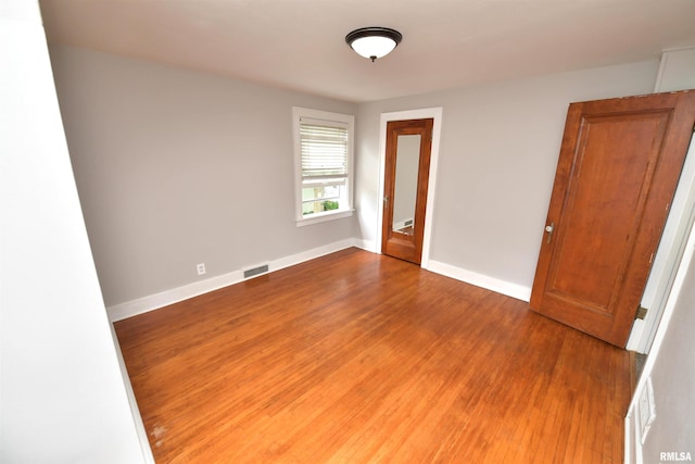 300 E Embert Pl, Peoria, IL 61603 - spare room featuring wood finished floors and baseboards