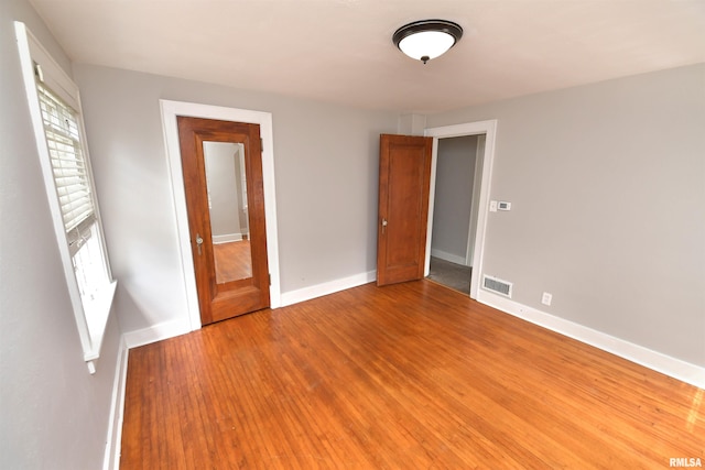 300 E Embert Pl, Peoria, IL 61603 - unfurnished bedroom with light wood-style floors and baseboards