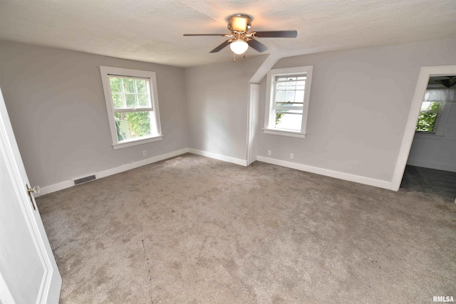 300 E Embert Pl, Peoria, IL 61603 - carpeted spare room featuring healthy amount of natural light, a ceiling fan, and a textured ceiling