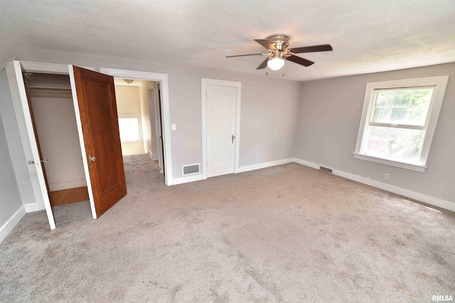 300 E Embert Pl, Peoria, IL 61603 - unfurnished bedroom with a textured ceiling, carpet flooring, and a ceiling fan