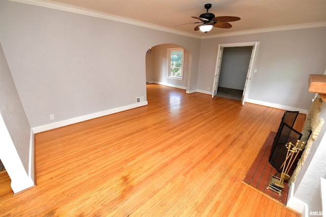 300 E Embert Pl, Peoria, IL 61603 - unfurnished living room with arched walkways, ceiling fan, wood finished floors, and ornamental molding