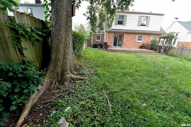 300 E Embert Pl, Peoria, IL 61603 - rear view of property featuring brick siding and a fenced backyard