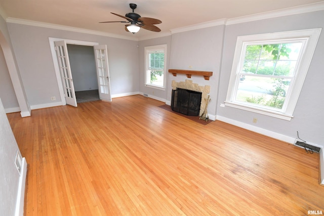 300 E Embert Pl, Peoria, IL 61603 - unfurnished living room featuring wood finished floors, a fireplace with flush hearth, a ceiling fan, crown molding, and french doors