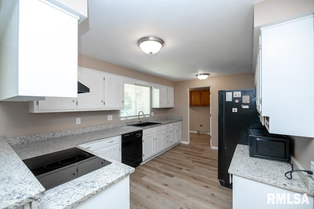 470 E Hazelwood St, Morton, IL 61550 - kitchen with black appliances, white cabinets, light wood-type flooring, and exhaust hood