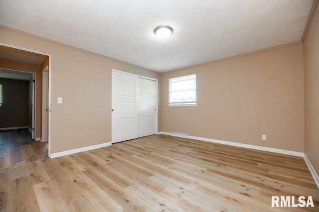 470 E Hazelwood St, Morton, IL 61550 - unfurnished bedroom with light wood-type flooring, a closet, and ornamental molding
